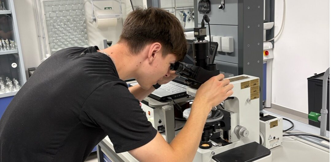 Guy looking through microscope