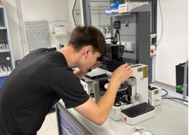 Guy looking through microscope