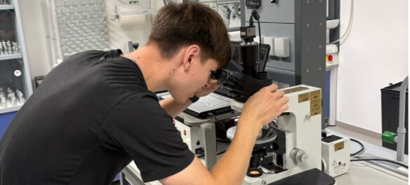 Guy looking through microscope