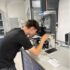 Guy looking through microscope