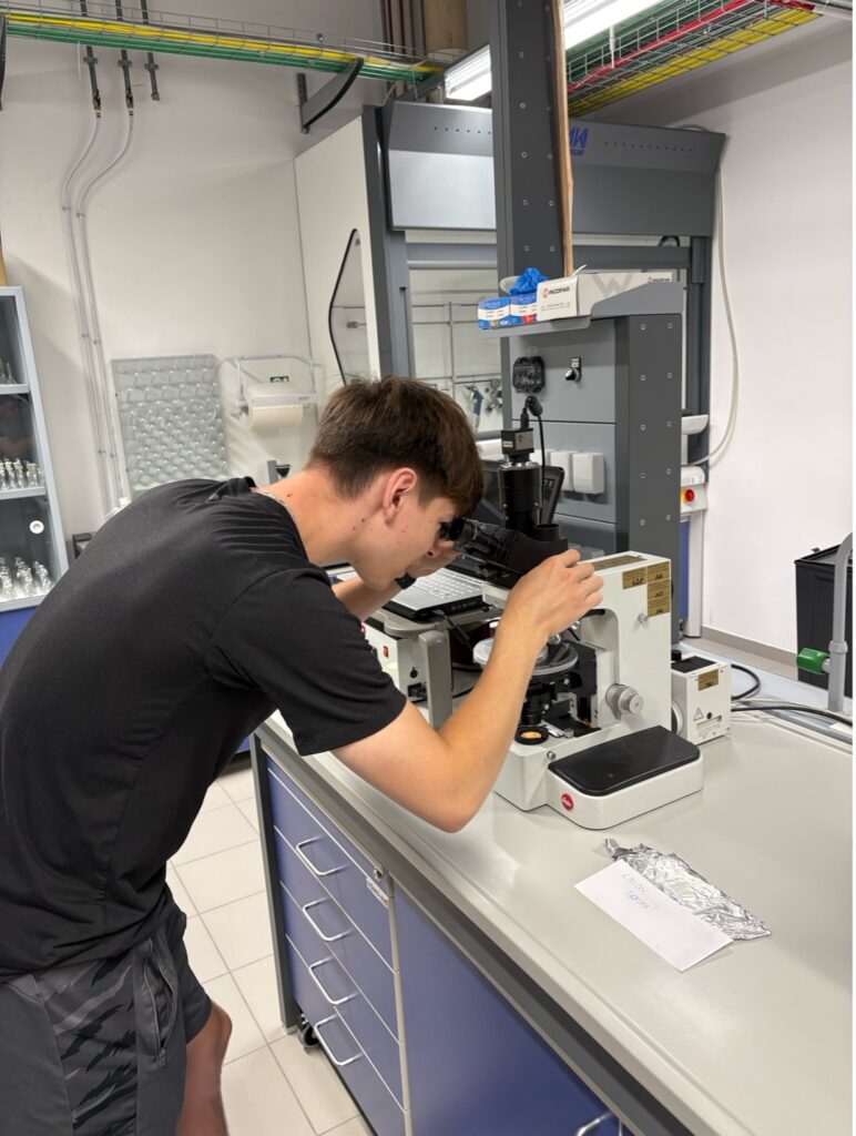 Guy looking through microscope